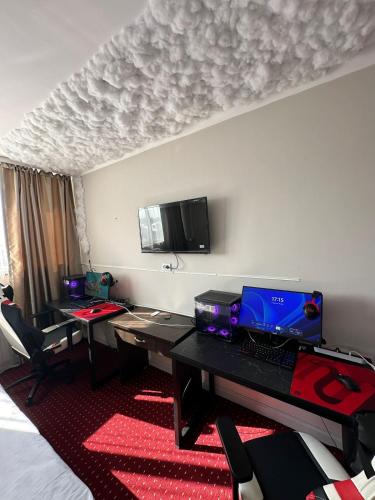 a hotel room with a desk with a laptop on it at Harmony Inn in Almaty