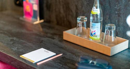 a couple of bottles on a table with a box at PLAZA Hotel Bruchsal in Bruchsal