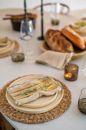 a table with plates of food and bread on it at Relax in Style at this Stunning Villa in Camps Bay, Cape Town in Cape Town