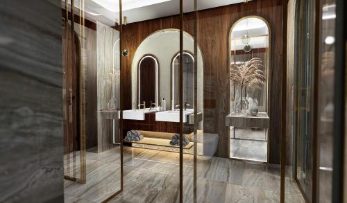 a bathroom with two sinks and a mirror at Grand Hotel Bristol in Stresa