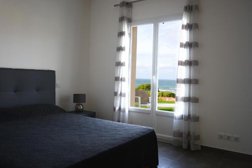 En eller flere senge i et værelse på Les Lauriers Roses