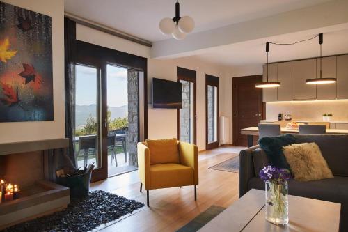 a living room with a couch and a fireplace at Alti Luxury Villa in Amfiklia