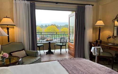 a hotel room with a bed and a balcony at Delamar Greenwich Harbor in Greenwich