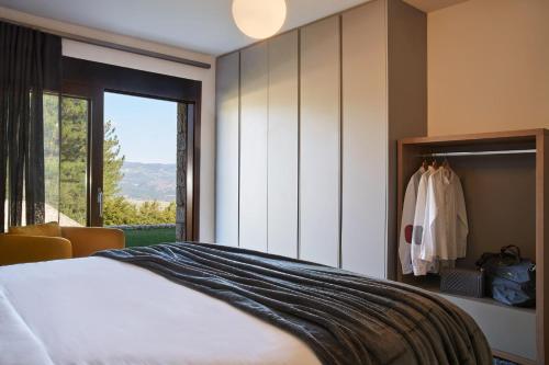 a bedroom with a bed and a large window at Alti Luxury Villa in Amfiklia