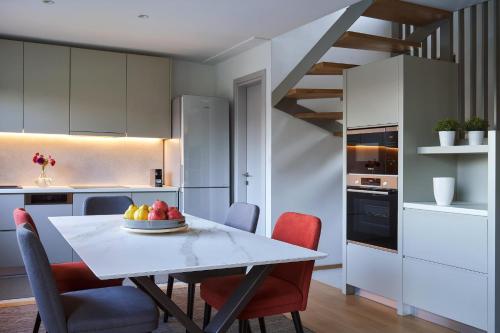 a kitchen with a table with a bowl of fruit on it at Alti Luxury Villa in Amfiklia