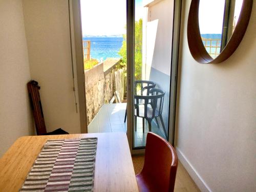 a dining room table with a view of the ocean at Glaz Ocean in Douarnenez