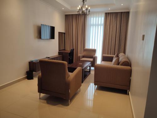 a living room with two chairs and a couch at Highland Rhinor in Eldoret