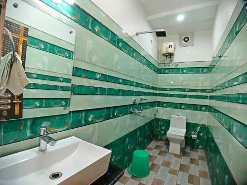 a bathroom with a sink and a toilet at Elegant Beach Resort in Mandarmoni