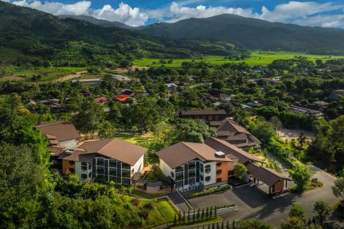 an aerial view of a village with mountains in the background at Tana Spring Resort Mae Chan in Chiang Rai