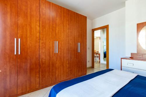 a bedroom with wooden cabinets and a bed at Appartamento Sisto - MyHo Casa in San Salvo