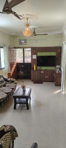 a living room with a couch and a table at Neelam Gardens in Nashik