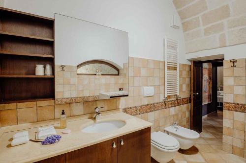 a bathroom with a sink and a toilet at Cuore 46&48 by Travel with Gianni in Monopoli