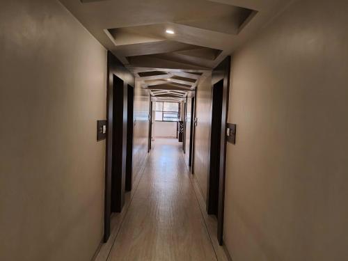 a corridor of an empty building with at Hotel Vijay Sagar Dombivali in Kalyan