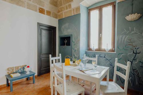 a dining room with a white table and chairs at Cuore 46&48 by Travel with Gianni in Monopoli