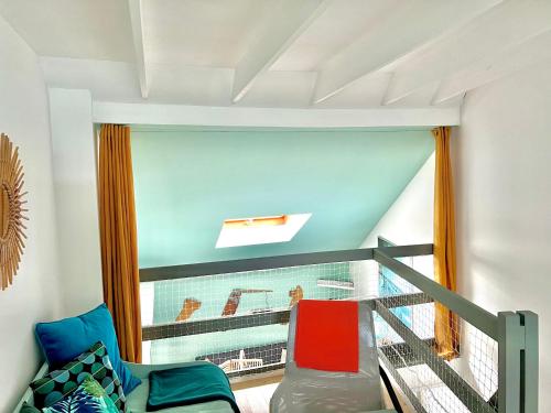 a room with a balcony with a couch and a window at Glaz Ocean in Douarnenez