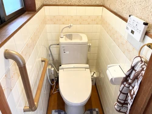 a bathroom with a toilet and a sink at Villa Hineno in Izumi-Sano