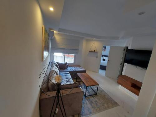 a living room with a couch and a table at Luxury marsa beach in La Marsa