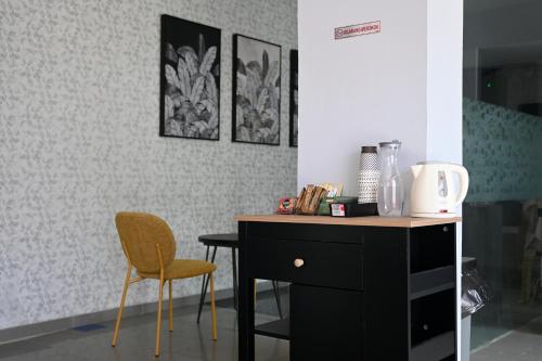 a desk and a chair in a room at Orens Inn in Manado