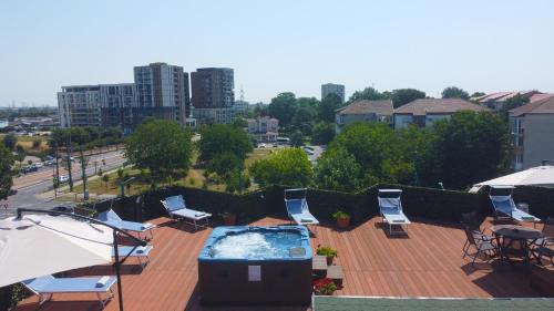 a hot tub on a roof with chairs and tables at Best Western Plus Lido Hotel in Timişoara