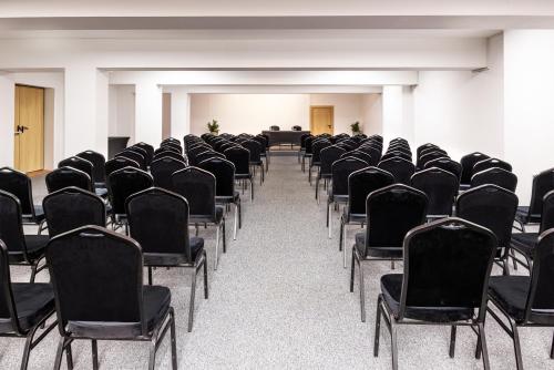 an empty room with black chairs in a building at Four Points by Sheraton Bansko in Bansko