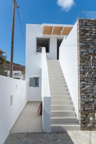 a staircase leading up to a white house at Deluxe Maisonette With Private Jacuzzi in Glifades