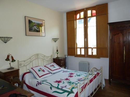 a bedroom with a bed and a window at Le Petit Quernon in Angers