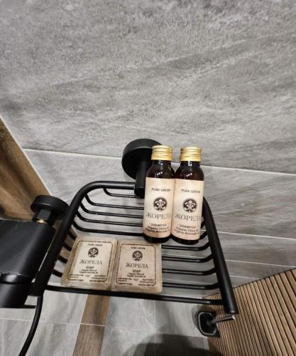 two bottles of honey sitting on a rack at Jorela Family Hotel in Ruse