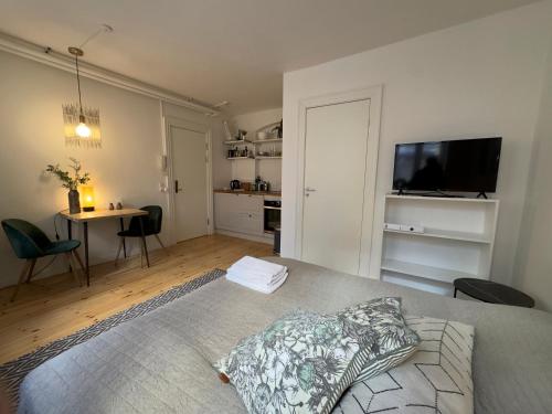 a bedroom with a bed with a pillow and a table at Kattesundet Apartments Best Location in Copenhagen in Copenhagen