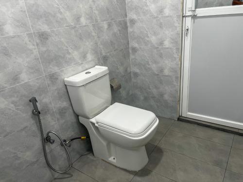 a bathroom with a toilet and a shower at Meridian Holiday Resort in Ratnapura