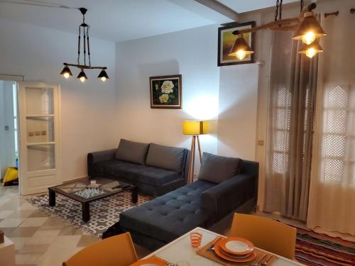 a living room with a couch and a table at heart of marsa beach in Douar el Hafey