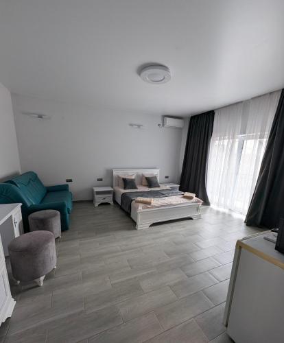 a living room with a bed and a chair at Ізумруд in Chop