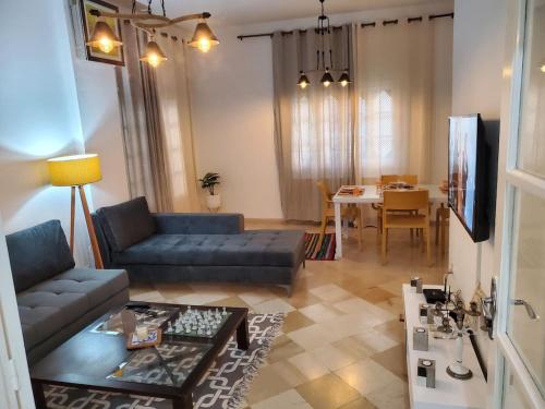 a living room with a couch and a table at heart of marsa beach in Douar el Hafey