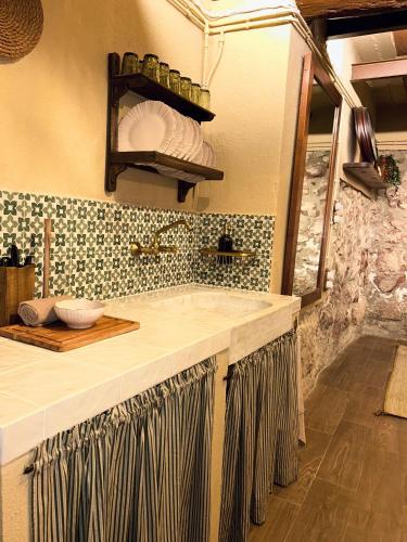 a kitchen with a counter top with a sink at Ca la Casilda in Prades