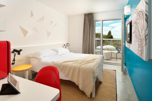 a hotel room with a bed and a balcony at Pharos Hvar Bayhill Hotel in Hvar