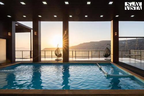 a large swimming pool with a view of the mountains at StayVista at Auburn Dusk with BBQ & Pool in Panchgani
