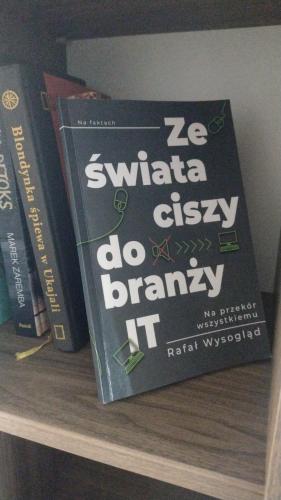a couple of books sitting on a book shelf at New Apartment Wroclaw Parking Place & Self Check in 24H Apartament TARAS Miedziana in Wrocław