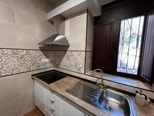 a kitchen with a sink and a window at Pósito de Don Juan in Fuente Victoria