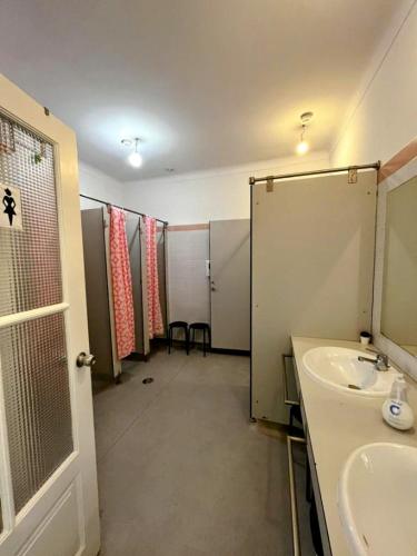 a bathroom with a shower and a sink and a mirror at AirPorto Hostel in Maia