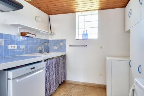 a kitchen with a sink and a window at Maison pour 7 à 900m de la plage avec jardin in Barbâtre