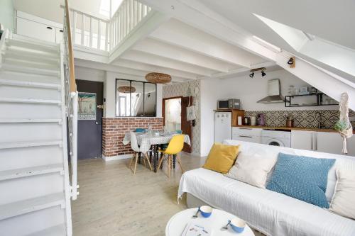 un salon avec un canapé blanc et une table dans l'établissement Appartement pour 4 à 200m de la plage du Prieuré, à Dinard