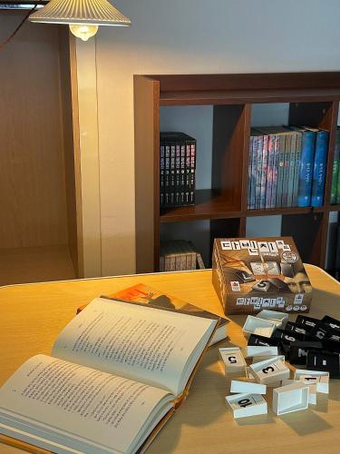 an open book on a table next to a book at Grape Residence Hotel in Incheon