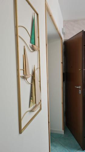 a mirror hanging on a wall next to a door at Znc Holiday House in Cetara