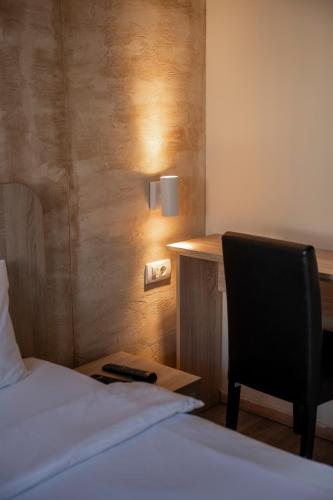 a bedroom with a bed and a desk and a chair at Villa ARS in Belgrade