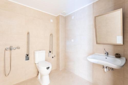 a bathroom with a toilet and a sink at Petrino Serene Studios in Kakóvatos