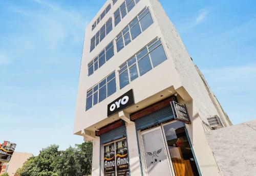 a tall white building with a noo sign on it at Hotel O ANNU RESIDENCY in Alīgarh