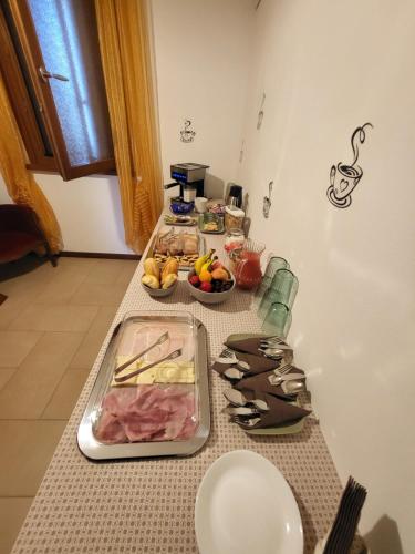 a kitchen counter with a table with food on it at b&b ALLE AGAVI in Mereto di Capítolo