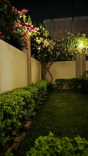 a garden at night with flowers and a fence at Shree Nanda Guest House in Varanasi