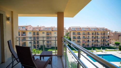 a balcony with chairs and a view of a building at Unique Residence Hotel Golf and Spa in Soke