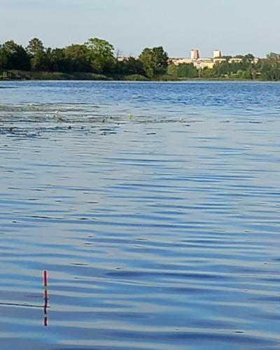 a large body of water with a red object in the water at Kubusiowy Zakątek in Ełk