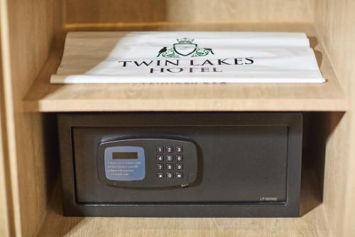 a microwave oven with a box on top of it at Twin Lakes Hotel near Tagaytay in Tagaytay